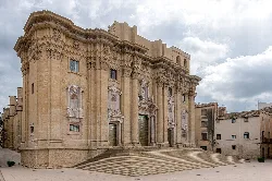 West façade of Tortosa Cathedral with stairs and architectural details in stone.