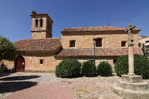 San Miguel Arcángel Church in Villamayor with tower and stone facade.