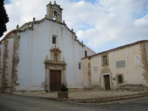 White hermitage facade with bell tower in Benlloc.
