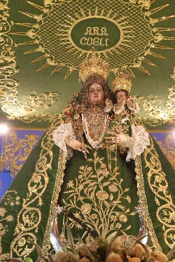 Virgin of Araceli with crown and dress during procession in Lucena.