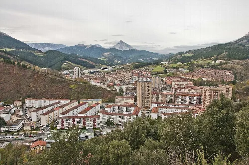 Blick auf die Stadt Mondragón mit Bergen und Gebäuden.