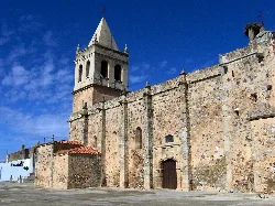 Parish church with stone wall and bell tower in La Garrovilla.