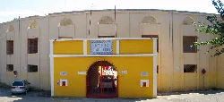 Entrance to the bullring with arch and red gate in Ricla.