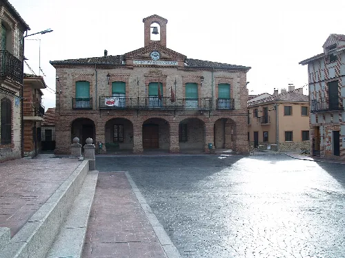 Town hall building with balconies and clock in Lastras de Cuéllar.