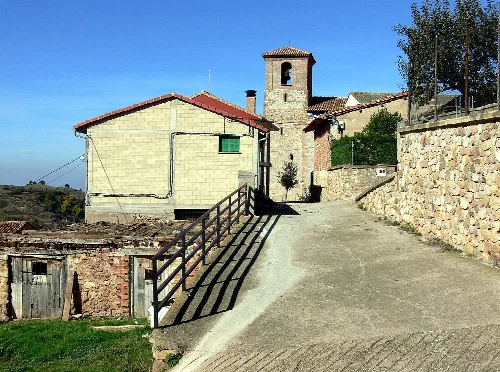 Street in Castroviejo with church and traditional houses.