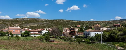 Landscape with houses and green hills in Peralejos de las Truchas.