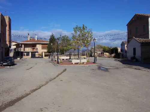 Square with trees, benches, and lampposts in Baños de Rioja.