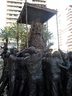 Sculptures of people in a monument in Huelva.