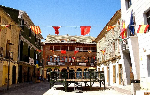 Plaza de España in Zuera with flags and old buildings.