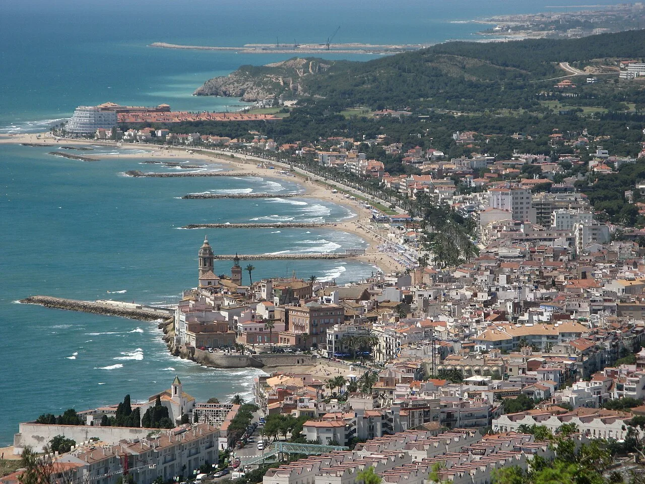 Aerial view of Sitges with beach, harbor, and buildings in Barcelona.