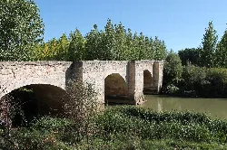 Stone bridge with multiple arches over the Duero River in Langa de Duero.
