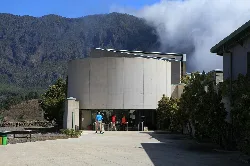 Modern visitor center building with people entering.