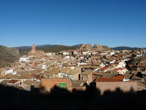 Urban landscape of Aranda de Moncayo with houses and castle on the hills.