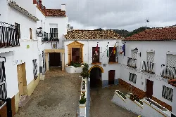 Town Hall building in Torre Alháquime with flags and white houses.