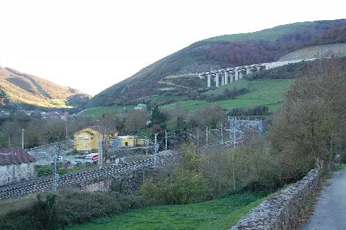 Paisaje de montaña con vías de tren y casas en Santiurde de Reinosa.