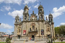 Facade of the sanctuary with tall towers and ornate details in Baños de Molgas.