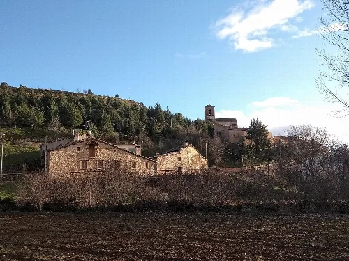 Houses and a church on the hill in Caballar.