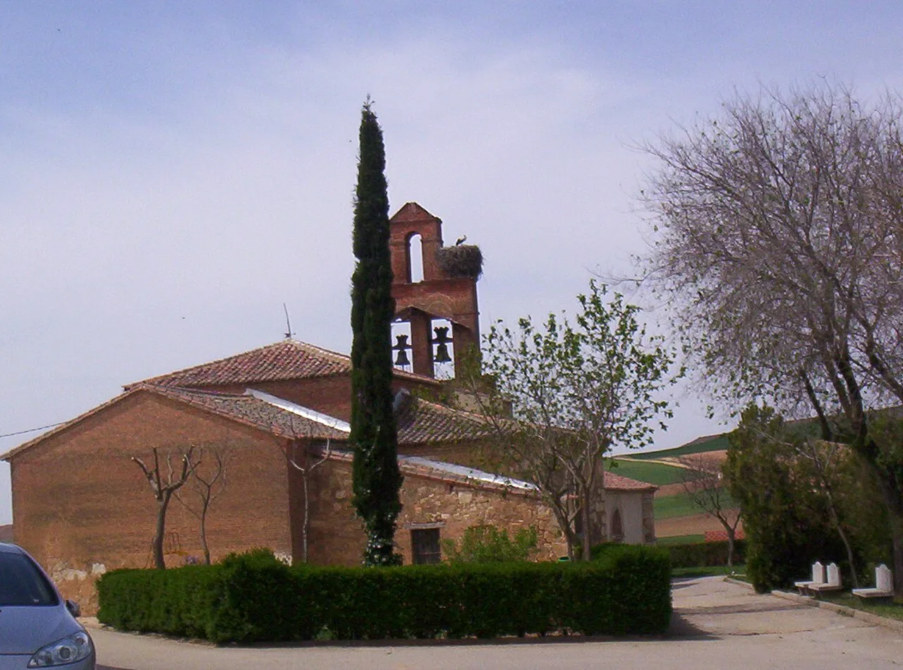 Church of San Juan Bautista with bell tower and trees in Gallegos del Pan.