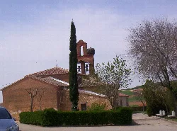 Church of San Juan Bautista with bell tower and trees in Gallegos del Pan.