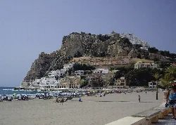 Vista del Teso de la Cala desde la playa de Benidorm con casas blancas en la ladera.