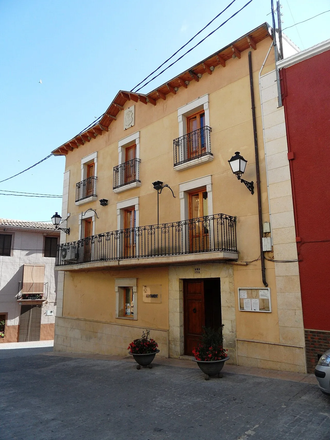 Town hall building with balconies and street lamps in Alfafara, Alicante.