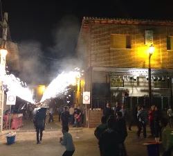 Fire bull with sparks during a nighttime festival in Valmojado.