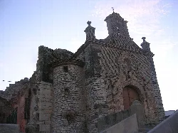 Stone hermitage with tower and cross in Almudévar.