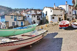 White houses and boats on the beach of Tazones, Villaviciosa.