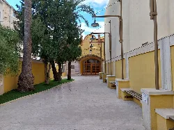 Entrance of the Wagner Theater with curved walkway and trees on the left.