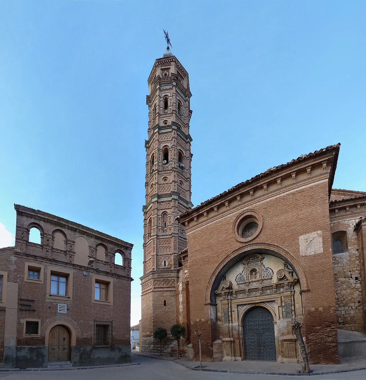 Kirche und Turm in Muniesa, Teruel, mit blauem Himmel.