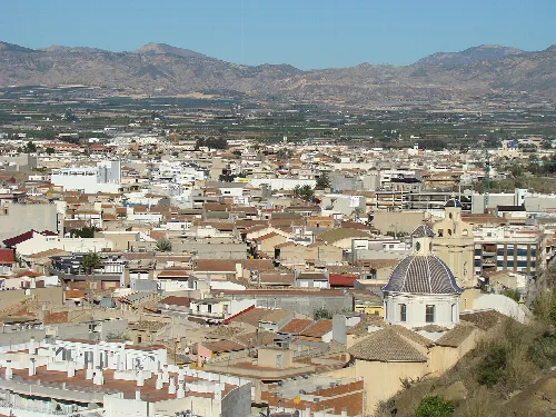Panoramic view of Cox's orchard with buildings and mountains.
