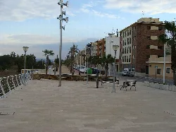 Avenue with benches and streetlights along the Magro river in Carlet.