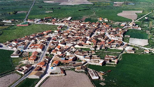 Aerial view of a town with narrow streets and traditional houses in the center.