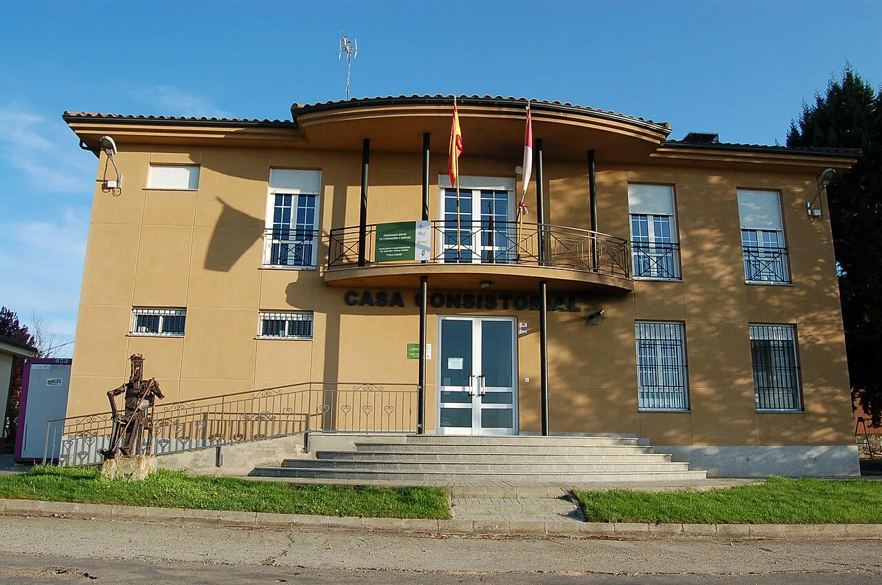 Town hall building with flags on the facade.