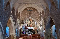 View of stone arches and altar inside the church.