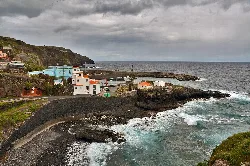 Colorful houses and a breakwater in Puerto Espindola, San Andrés y Sauces.