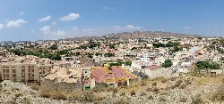 Cityscape with mountains in the background from the viewpoint.