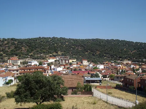 View of Pepino with houses and green hills.