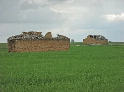 Clay mud silos in a green field in Fontihoyuelo.