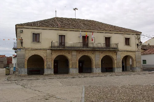 Town hall building with arches and balcony in Labajos.