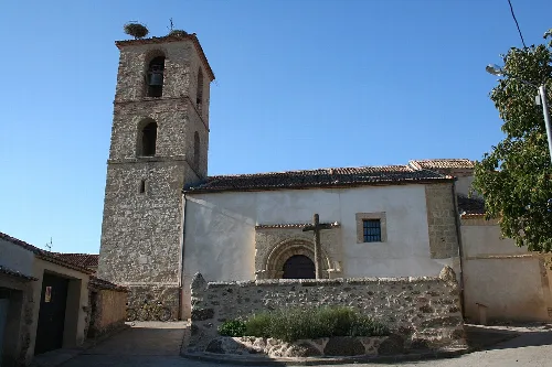 Church in Basardilla with tower and simple facade.