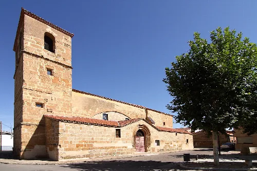 Parish church of Huerta with tower and arched door.