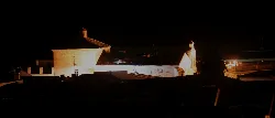Church of La Concepción in Guadalcanal lit up at night.