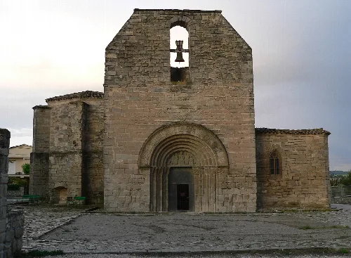 Stone church facade with a ruined bell tower in Santa Coloma de Queralt.