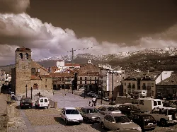 Main square with church and mountains in Béjar.