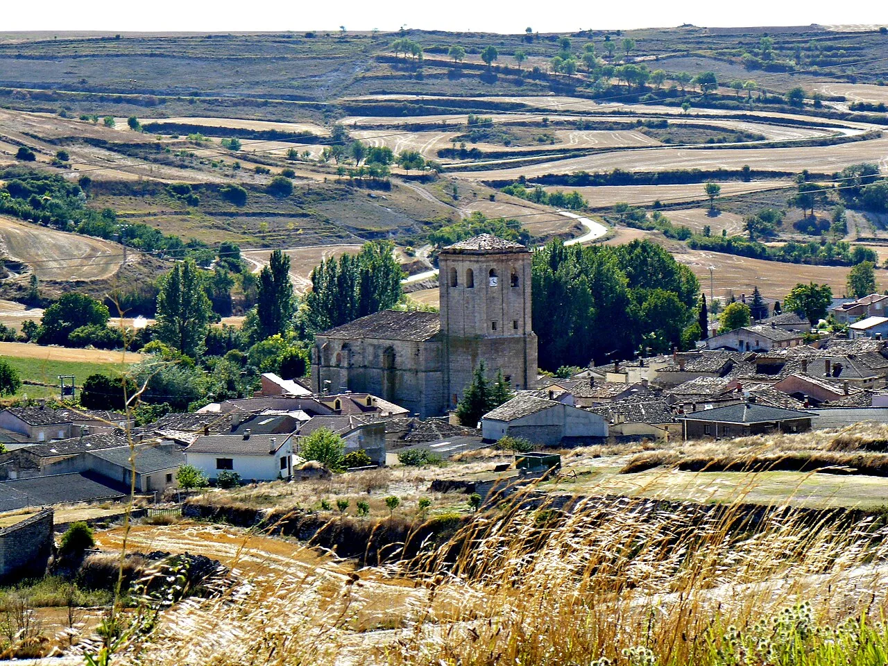 View of a church and houses in a rural village in Burgos.
