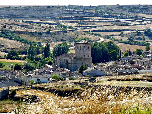 View of a church and houses in a rural village in Burgos.