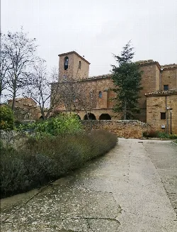 Stone church with tower and arches in Garínoain, Navarra.