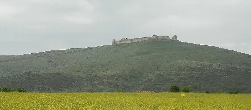 Blick auf die Alcazaba auf einem Hügel bei bewölktem Himmel.