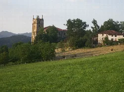 Ama Jasokundea church in Segura, Guipúzcoa, with bell tower and trees.